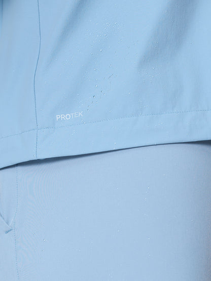 Close up of water droplets on sky blue Flex Jacket fabric highlighting ProTek water resistant finish