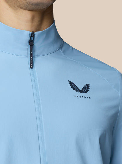 Close up of sky blue Castore Flex Jacket with front zipper and logo on the chest