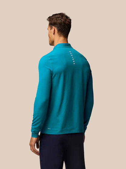 Back view of blue Golf 1/2 Zip Top on a male model with vertical CASTORE branding along the upper back.