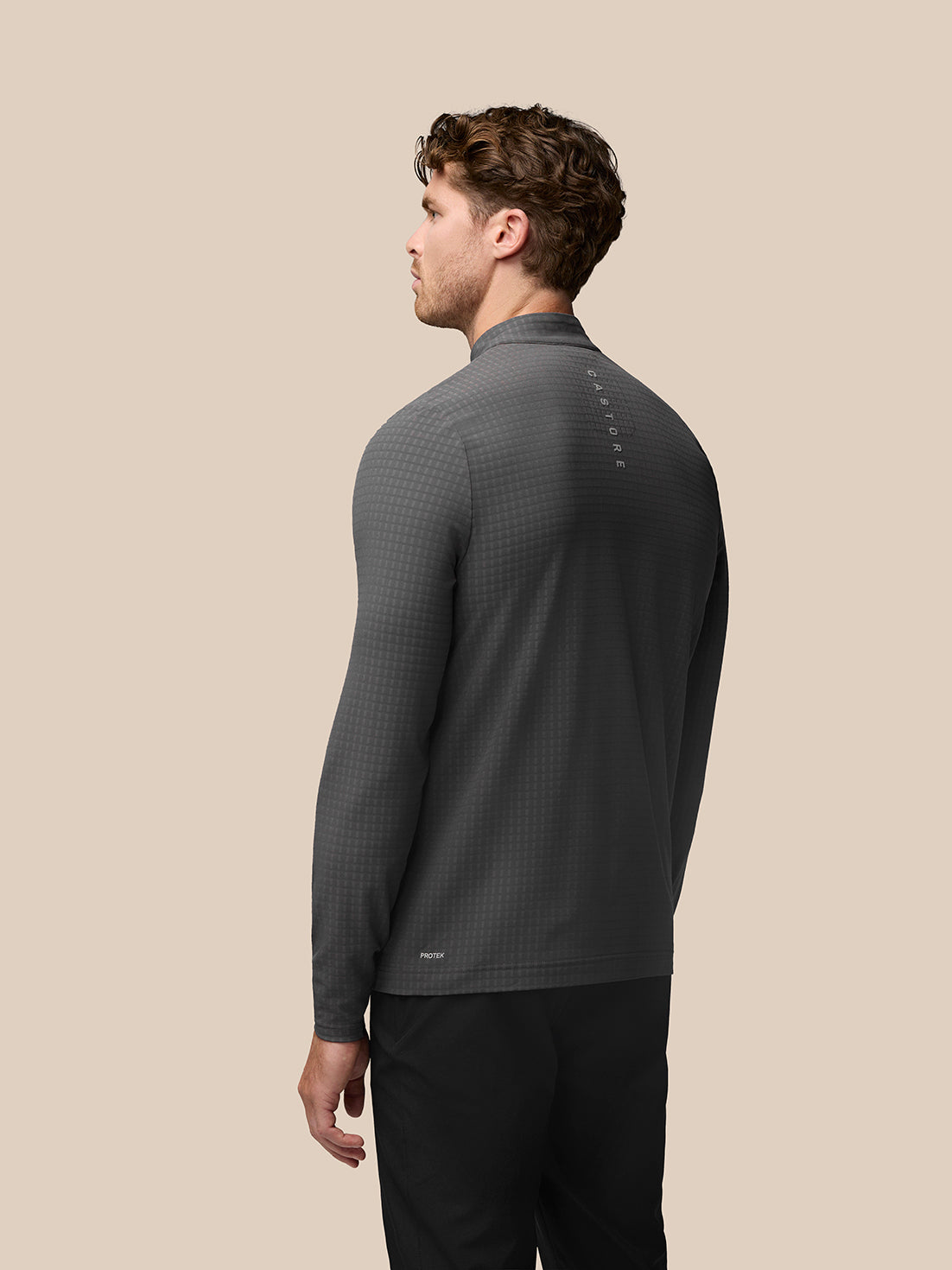 Back view of grey Castore Golf 1/2 Zip Top with a subtle grid texture and center back branding