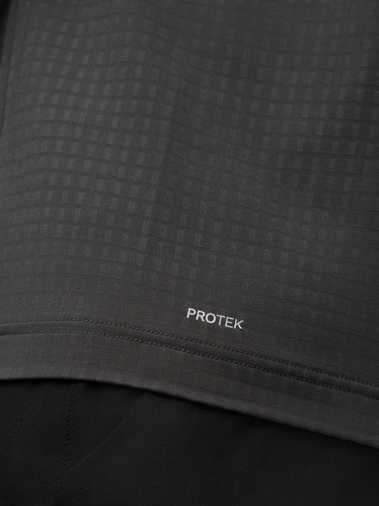Close up of dark grey Protek fabric with subtle check pattern and Protek branding