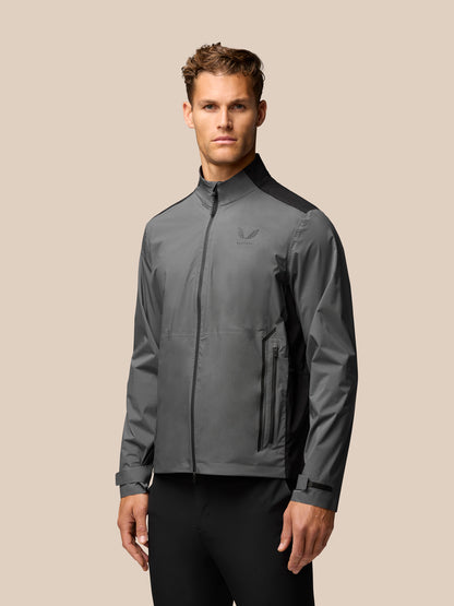 Model wearing gunmetal golf waterproof jacket with stand collar and zip pockets