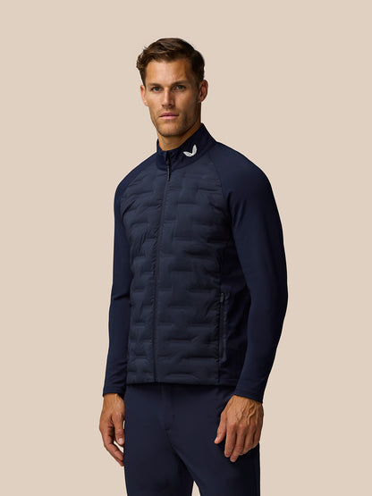 Male model wearing Golf Pinnacle Jacket in midnight navy with quilted front panel and stand collar