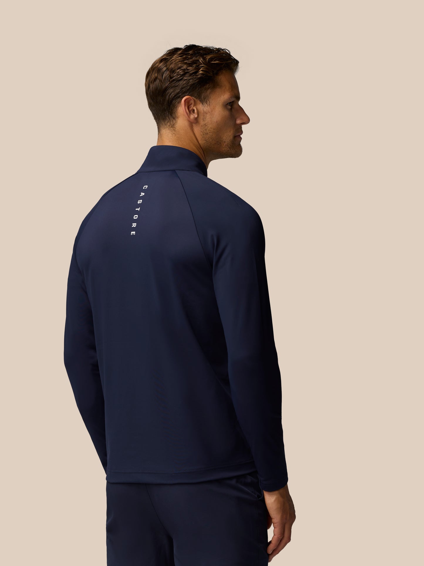Back view of midnight navy Golf Pinnacle Jacket with Castore branding on upper back