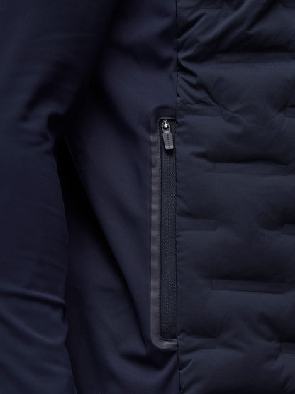 Close up of navy Pinnacle Jacket zipper along a pocket with auto lock puller