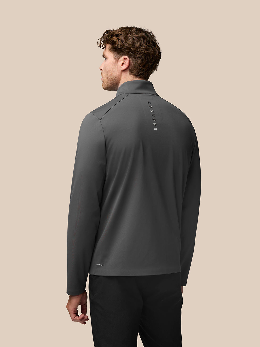 Back view of Garcia Hybrid Jacket in charcoal on a model with Castore branding along the upper back.