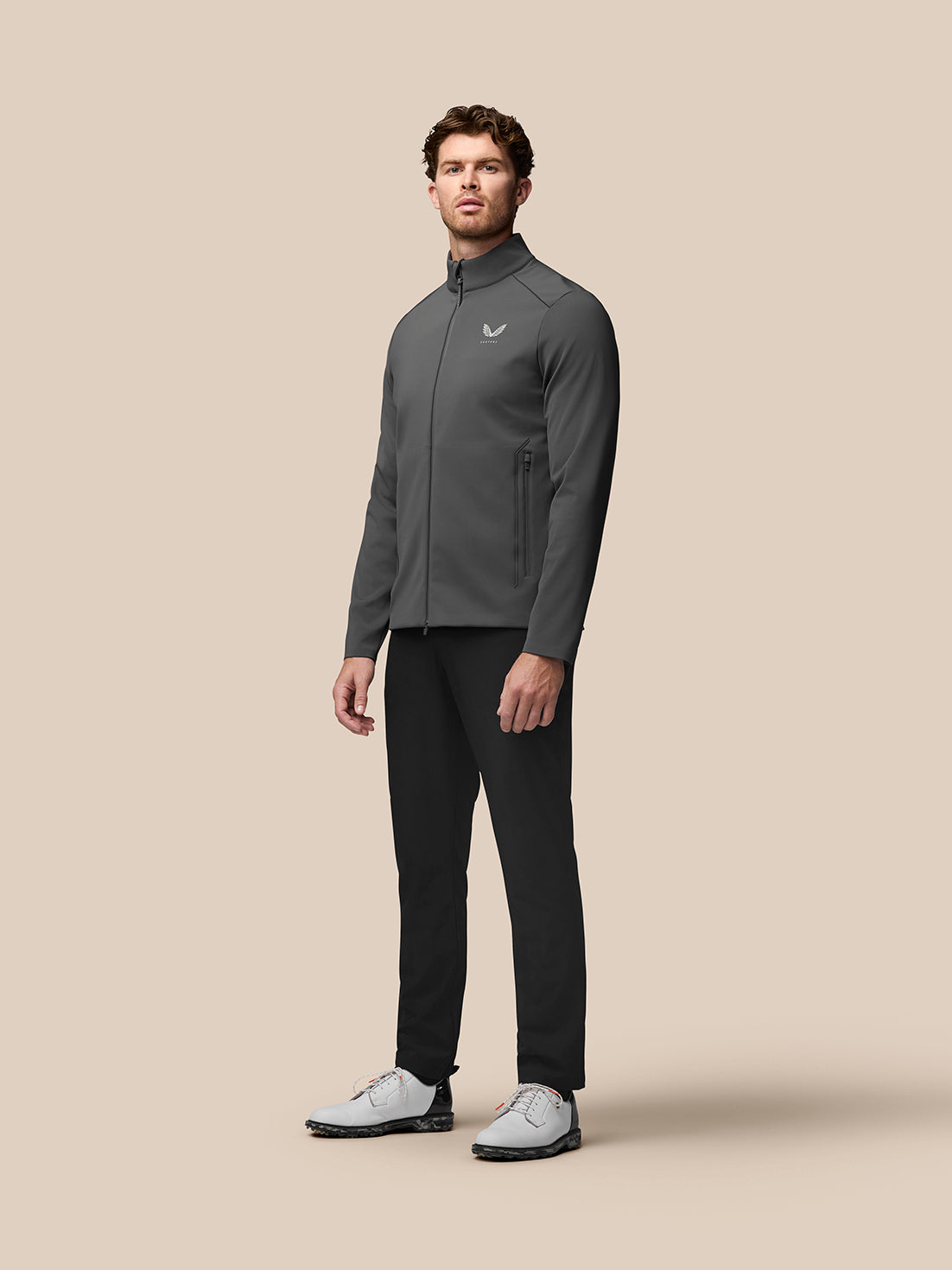 Male model wearing Garcia Hybrid Jacket in charcoal, showcasing stand collar and zip pockets.