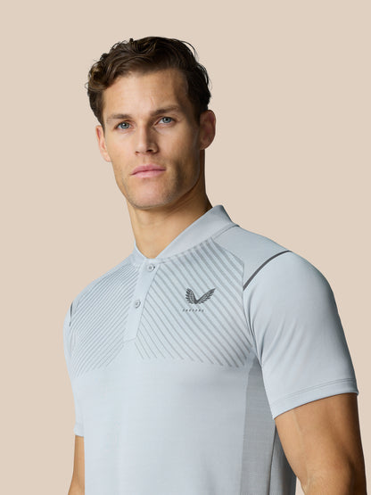 Male model wearing Pinnacle Golf LVS Polo in mid grey with diagonal chest stripes and logo