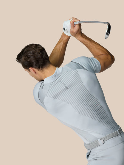 Golfer in mid grey Pinnacle Golf LVS Polo during a swing with back diagonal stripe panels visible