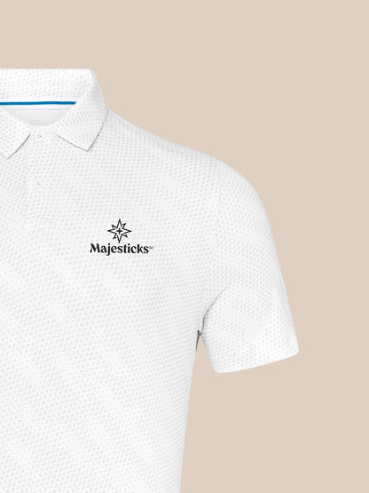 White Majesticks polo with golf ball print and left chest logo against a beige background