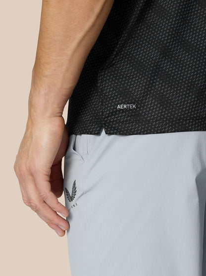 Close-up of Club Graphic Polo Black with dotted texture and AERTEK branding at hem