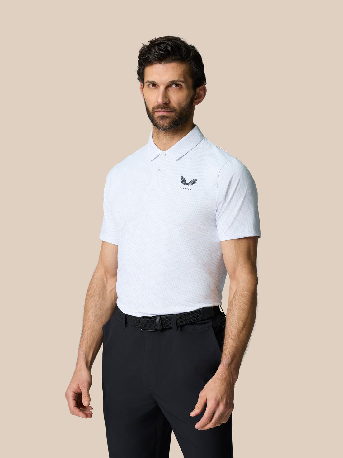 Model wearing Club Graphic Polo in white with golf ball print and Castore branding on chest