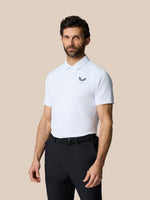 Model wearing Club Graphic Polo in white with golf ball print and Castore branding on chest