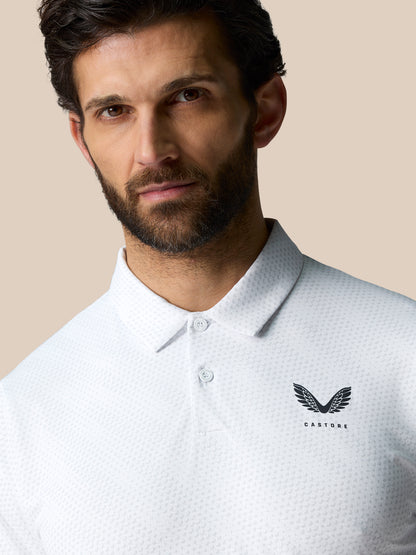 Front view of a man wearing a white Club Graphic Polo with a textured dot pattern and Castore logo on the left chest.