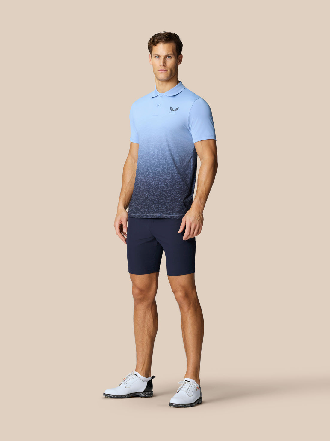 Male model wearing sky blue Club Graphic Polo featuring an ombre gradient and Castore logo on chest