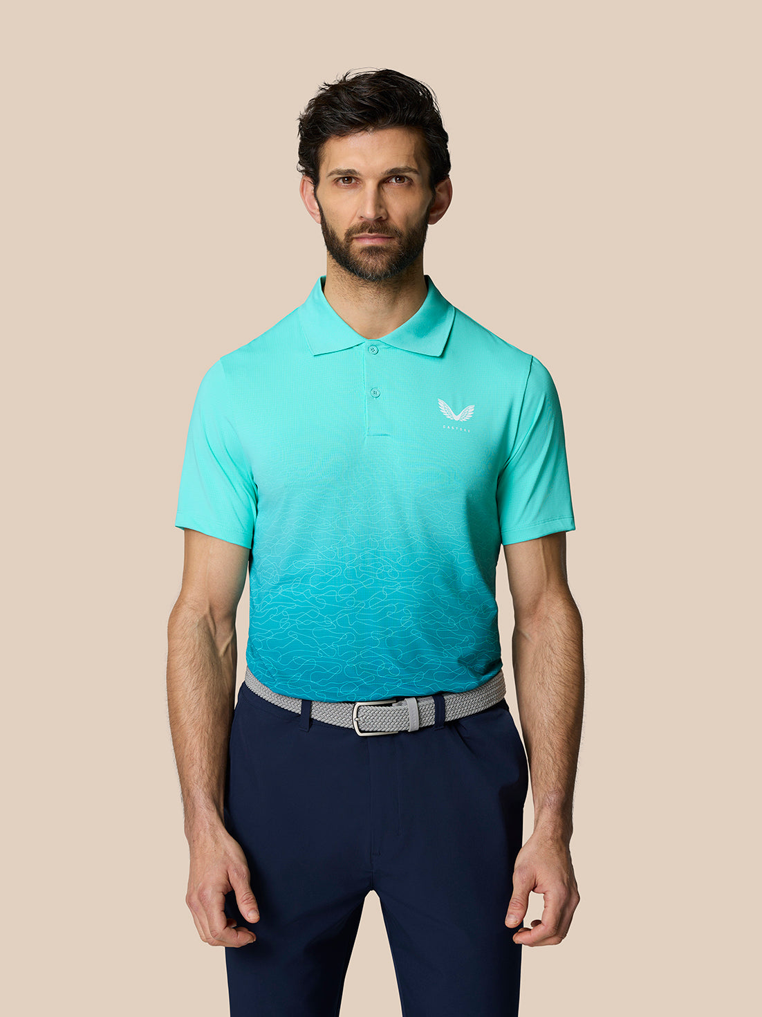Front view of a male model wearing the Club Graphic Polo in light aqua with an ombre wave pattern and a Castore logo on the chest
