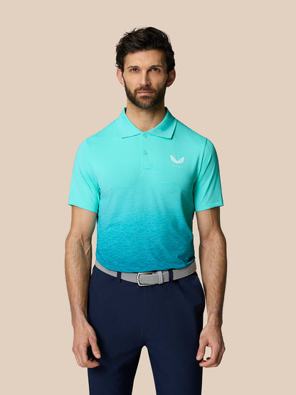 Front view of a male model wearing the Club Graphic Polo in light aqua with an ombre wave pattern and a Castore logo on the chest