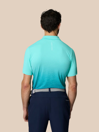 Back view of the Club Graphic Polo in light aqua with an ombre pattern and vertical Castore branding along the upper back