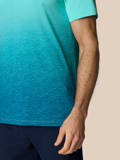 Model wearing Club Graphic Polo Light Aqua with ombre print and short sleeves.