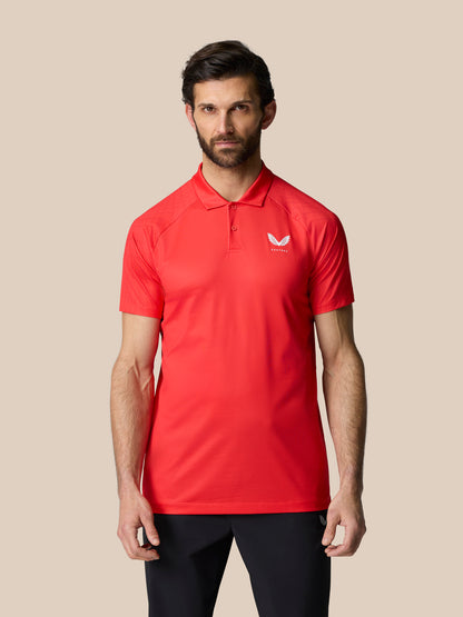 Male model wearing red Club Graphic Polo with polo collar and short sleeves and white logo on left chest.
