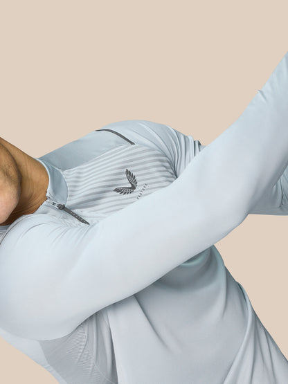 Model wearing mid grey Pinnacle LVS 1/4 Zip Top with a quarter zip and subtle striped knit.