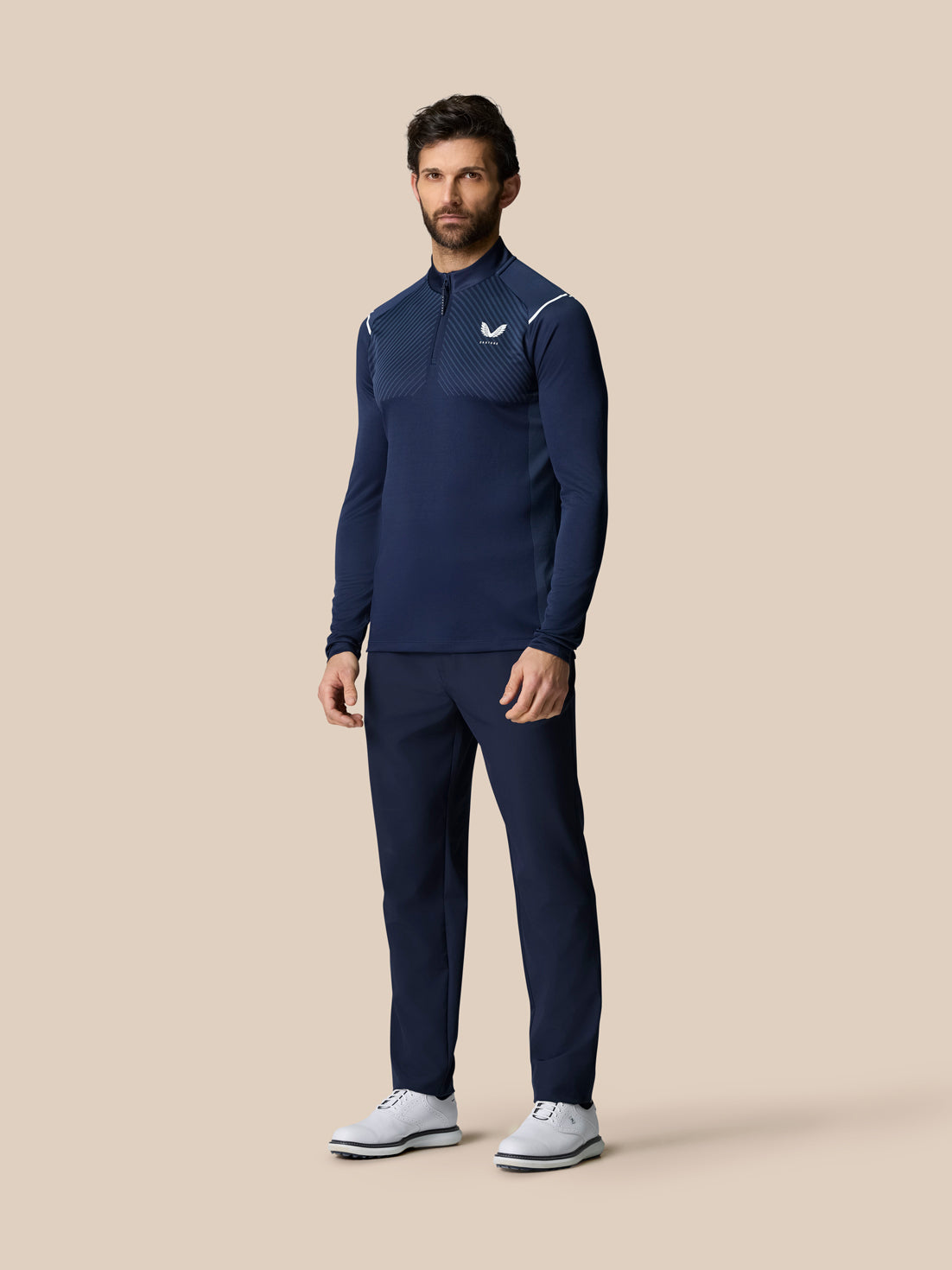 Front view of a man in navy Pinnacle LVS 1/4 Zip Top with diagonal vented chest pattern and quarter zip.