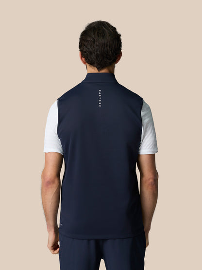Back view of navy half zip golf gilet on a male model with Castore branding down the back