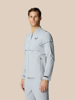 Light grey Golf Pinnacle LVS Woven Jacket worn by a male model with full zip front stand collar and zip pockets