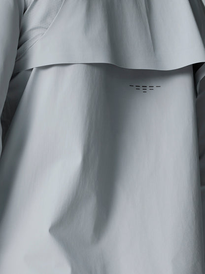 Front chest of the light grey Golf Pinnacle LVS Woven Jacket with zipper and Castore logo.