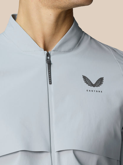 Back view of the light grey Golf Pinnacle LVS Woven Jacket with curved hem and vent detail.