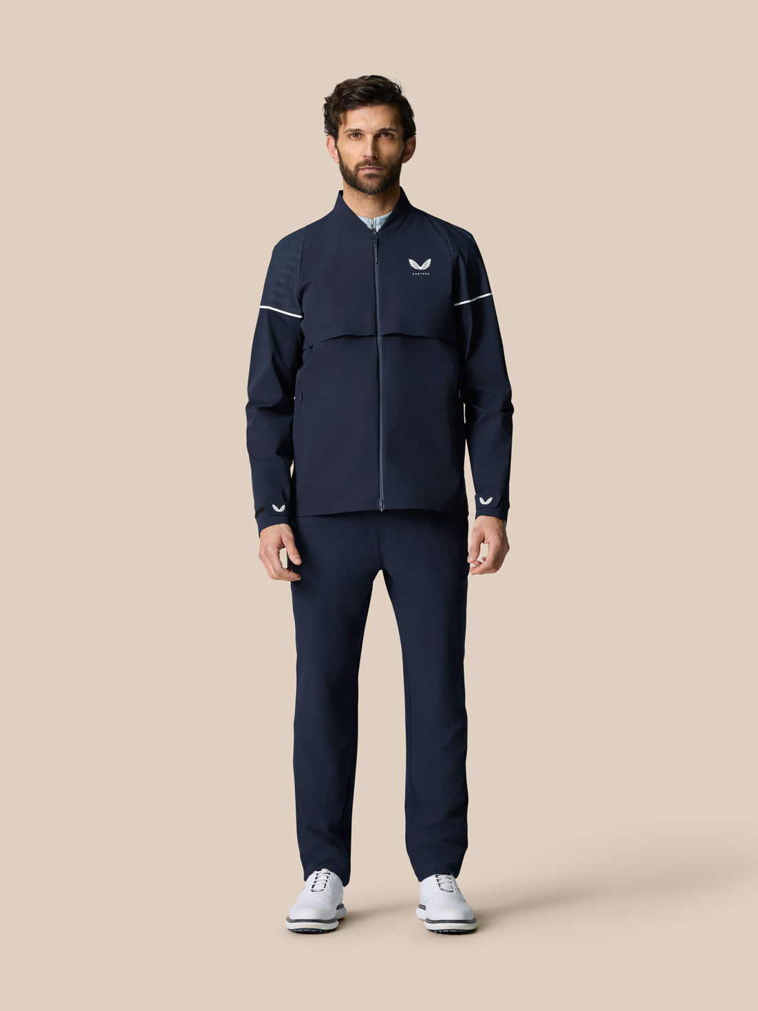 Male model wearing Golf Pinnacle LVS Woven Jacket in midnight navy