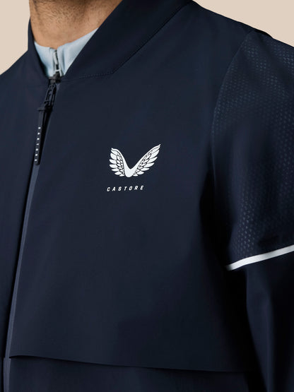 Close up of left chest area with Castore logo on Midnight Navy Golf Pinnacle LVS Woven Jacket along the front zipper