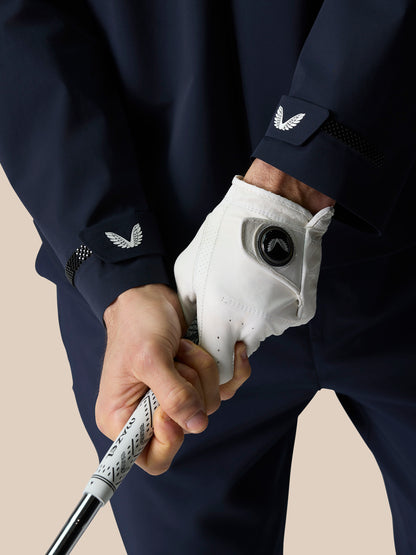 Close up of the cuff on Midnight Navy Golf Pinnacle LVS Woven Jacket showing Castore emblem and mesh trim