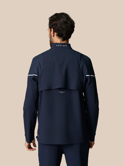 Back view of midnight navy LVS Woven Jacket showing venting panels and neck logo