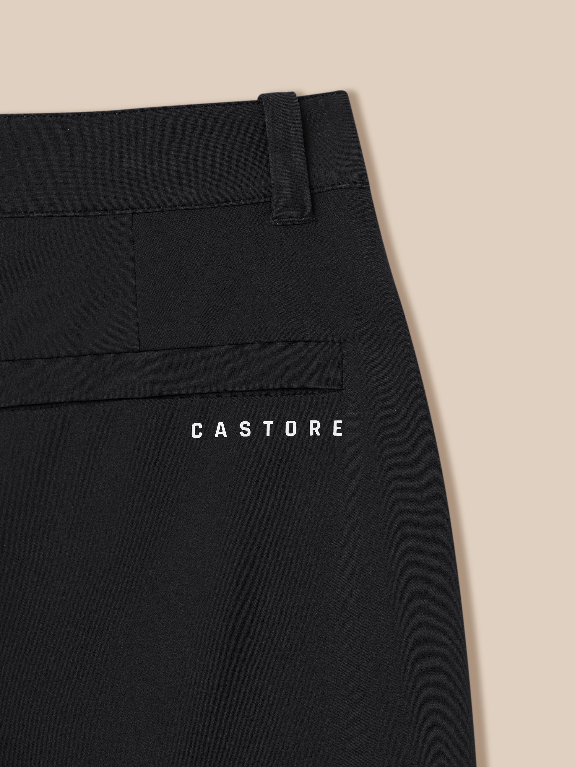 Close-up of black Golf Pinnacle trouser waistband with belt loop and back pocket seam, CASTORE branding