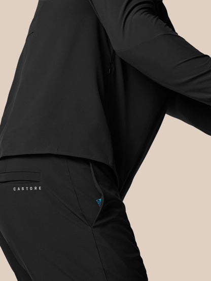 Close-up of black Castore golf trouser showing back pocket with logo and blue zipper pull.