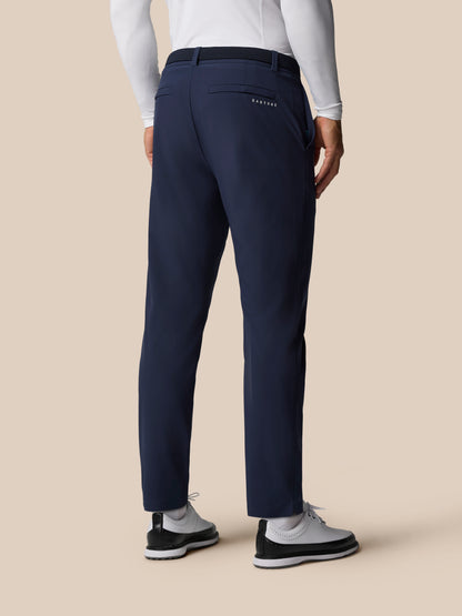 Back view of midnight navy Golf Pinnacle Trouser showing belt, back pocket, and Castore branding.
