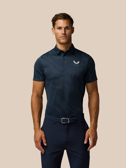 Male model wearing Pinnacle Glow Polo in midnight navy with striped knit pattern and left chest logo