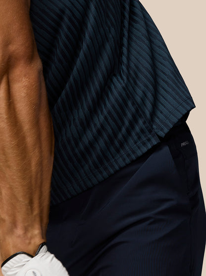 Close up of navy striped knit polo fabric showing vertical stripes and Castore logo on chest