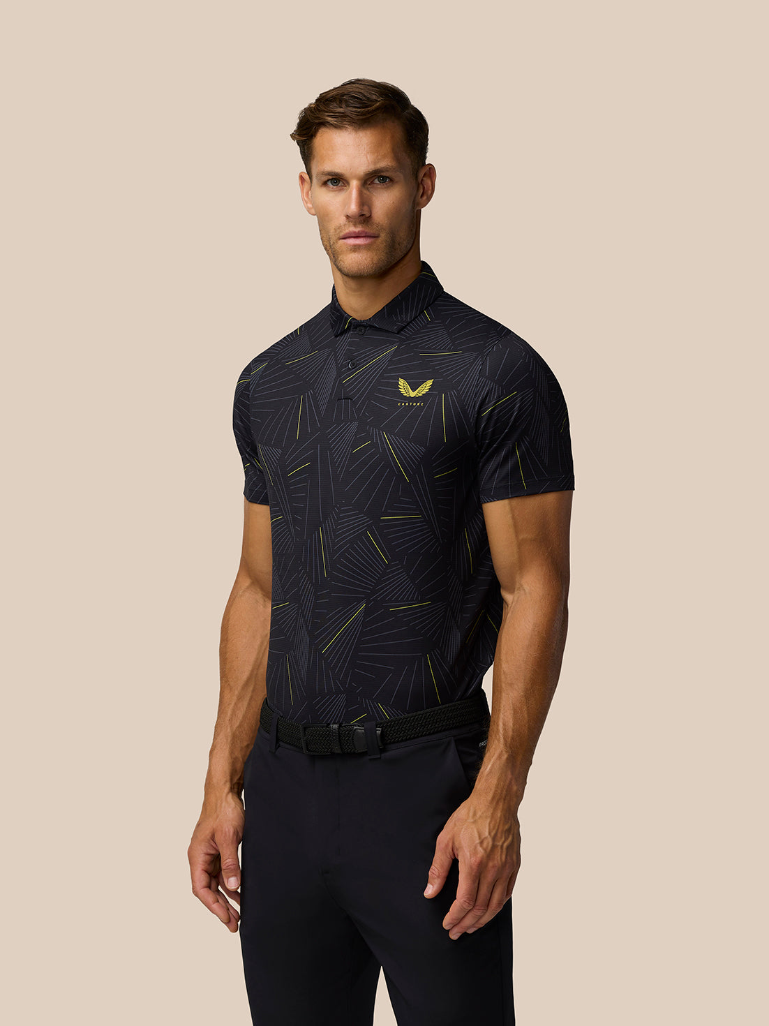 Male model wearing black Golf Club Swing Polo with a geometric line print and Castore logo on the left chest