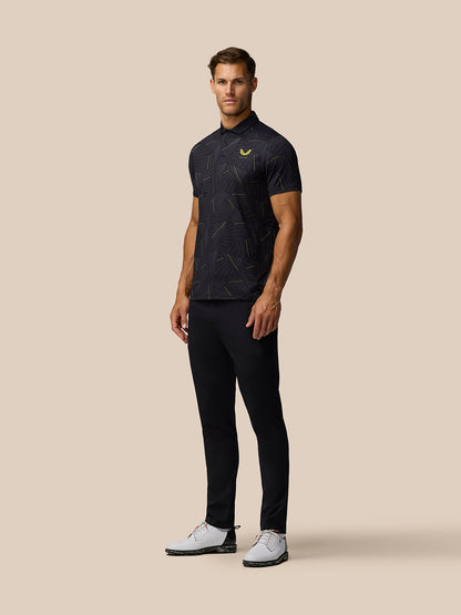Full body view of male model in black Golf Club Swing Polo with dark trousers and white golf shoes