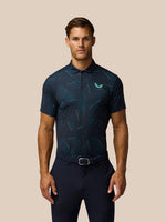 Male model wearing midnight navy printed golf polo with aqua geometric lines and Castore logo on left chest