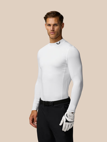 Male model wearing white Golf Club Long Sleeve Thermal Mock Neck top with glove in hand