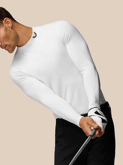 Male model wearing white Golf Club Long Sleeve Thermal Mock Neck top with midnight navy branding at the neck