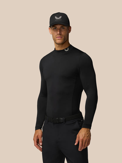 Male model in black Castore Golf Club thermal mock neck top with cap and belt