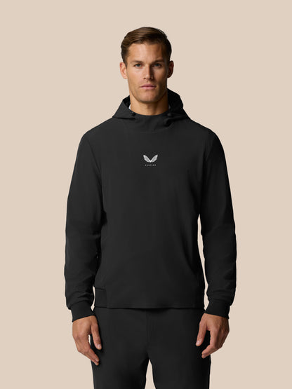 Front view of man wearing black Golf Pinnacle Performance Hoodie with white Castore logo on chest
