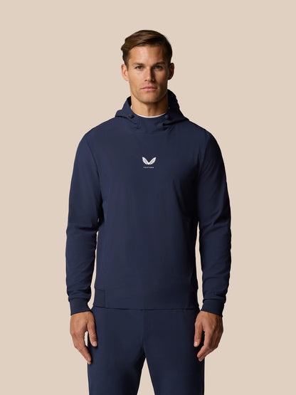 Man wearing midnight navy Golf Pinnacle Performance Hoodie with hood and white Castore logo on chest
