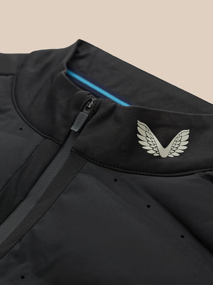 Male model in black Golf Pinnacle LVS Hybrid 1/2 Zip Top, showcasing the layered ventilation system.