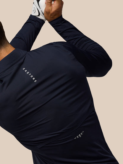 Close up of the navy golf top showing Castore branding on the back shoulder with ventilation detailing.