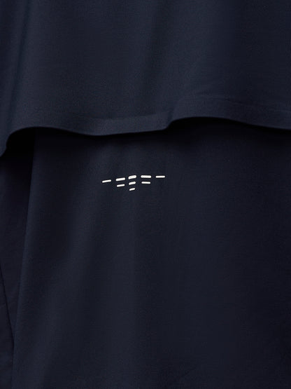 Close-up of navy fabric with PROTEK branding near a seam on the jacket